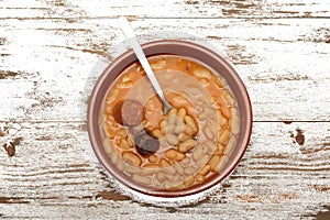 Asturian bean stew in a clay pot. photo