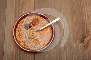 Asturian bean stew in a clay pot. photo