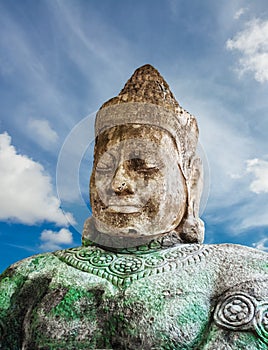 Asura statue on blue sky background photo