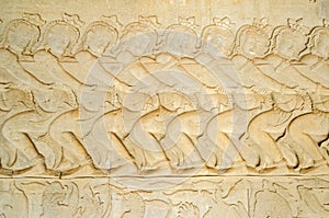 Asuras using the serpent Vasuki to churn the sea on the bas-relief of the Churning of the Sea of Milk in Angkor Wat photo