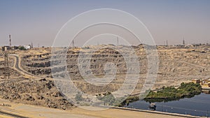 Aswan dam on the Nile. A highway, power lines and towers, technological buildings are visible