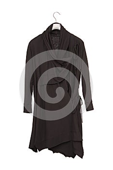 Asymmetrical model of female garment, asymmetric black dress, cotton tunic on white background, isolated wraparound gown