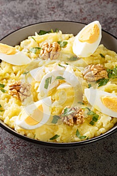 Atascaburras the delicious combination of potatoes, cod and garlic from Castile La Mancha closeup on the bowl. Vertical photo
