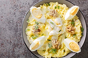 Atascaburras typical dish of Spanish Castilian La Mancha potato, cod, egg and walnuts closeup on the bowl. Horizontal top view