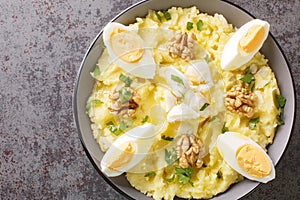 Atascaburras typical dish of Spanish Castilian La Mancha potato, cod, egg and walnuts closeup on the bowl. Horizontal top view photo