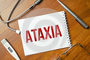 Ataxia inscription by stethoscope on wooden background