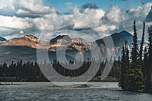 The Athabasca river flows by the Canadian rocky mountains in Alberta, Canada