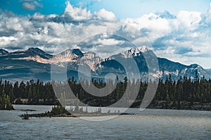 The Athabasca river flows by the Canadian rocky mountains in Alberta, Canada