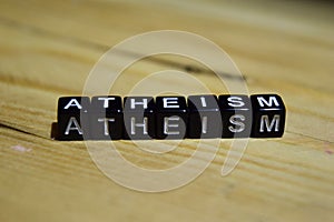 Atheism written on wooden blocks. Inspiration and motivation concepts