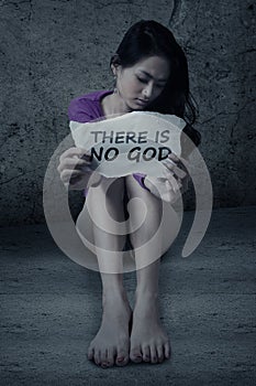 Atheist girl shows paper photo