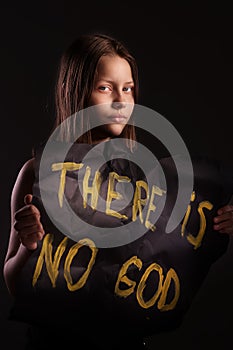 Atheist teen girl holding a banner with the inscription photo