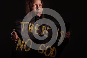 Atheist teen girl holding a banner with the inscription photo