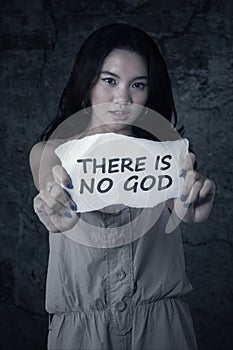 Atheist teenage girl holds paper photo