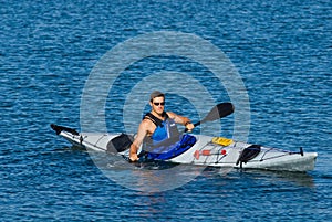 Atheltic man in a sea kayak