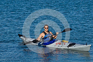 Atheltic man in a sea kayak