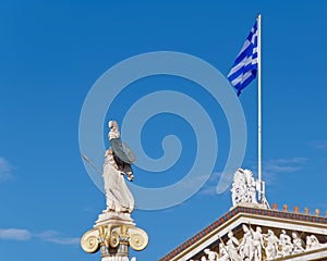 Athena statue the ancient Creek goddess of science and wisdom and Greek flag photo