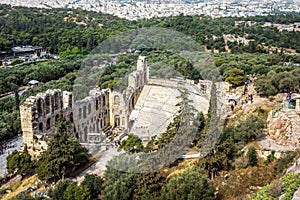 Athens city view from above, ruins of Odeon of Herodes Atticus at Acropolis, Greece. Ancient theater is famous landmark of Athens