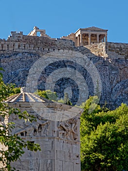 Athens Greece, ancient temple on acropolis hill over roman winds tower