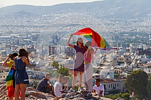 Girls holding flag on Athens Pride 2018 day being photographed b