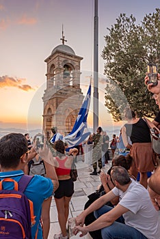 Military ceremony for the lowering of the Greek flag at sunset at Lycabettus Hill in Athens