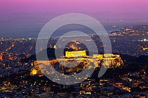 Athens postcard. Sunset view of Parthenon Temple at the Acropolis Hill, Athens and harbour. View from Mount Lycabettus. Athens,