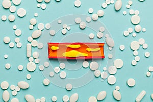 Atherosclerosis disease, narrowing of arteries due to plaque buildup on the artery walls on blue background with pills. Treatment