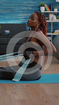 Athetic black woman in sportswear watching aerobic online sport workout photo