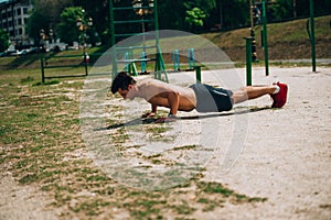 Athlet wearing black shorts making static exercise