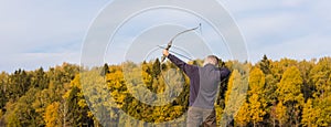 Athlete aiming at a target and shoots an arrow. Archery, banner