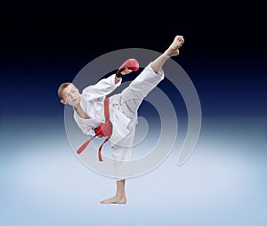 The athlete beats roundhouse kick on the gradient background