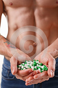 Athlete bodybuilder takes dope in the form of tablets form of pharma rapid progress in muscle