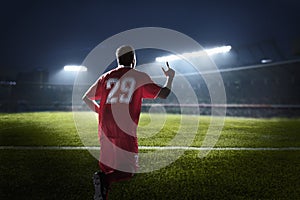 Athlete cheering in a stadium at night