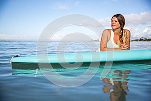 Athlete chilling on her paddle board in Hawaii