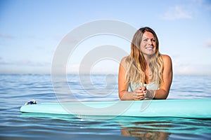 Athlete chilling on her paddle board in Hawaii