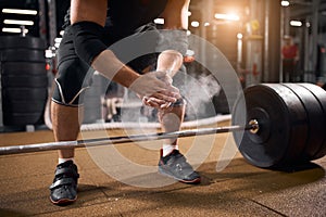 Athlete clapping hands before deadlift