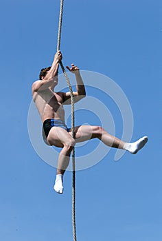 Athlete Climbing Up the Rope