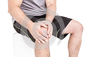 Athlete clutching knee in excruciating pain