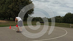 Athlete collects orange cones from the basketball court