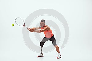 Athlete with disabilities or amputee isolated on white studio background. Professional male tennis player with leg