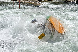 Athlete does stunts with canoe on the river