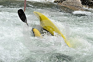 Athlete does stunts with canoe on the river