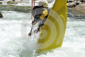 Athlete does stunts with canoe on the river for sport