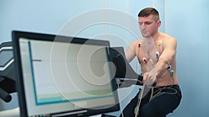 An athlete doing a cardiac stress test using a medical bike.