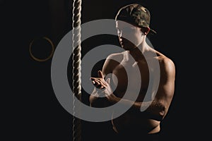 Athlete doing Fitness Rope Climb Exercise In Fitness Gym Workout