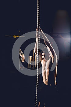 Athlete doing Fitness Rope Climb Exercise In Fitness Gym Workout