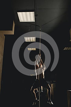 Athlete doing Fitness Rope Climb Exercise In Fitness Gym Workout