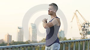 Athlete doing morning exercises and running along street to recover from injury