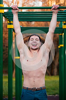 Athlete doing pull-up on bar