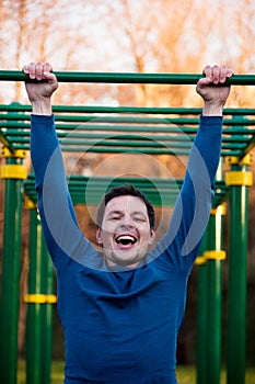 Athlete doing pull-ups on bar