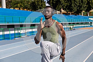 Athlete doing warm-up exercises on athletics track